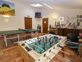 A recreation room with table tennis and foosball tables at Churn House in Ipswich
