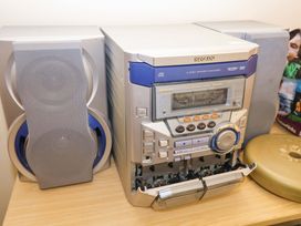 A stereo system with speakers and a disc player at Churn House in Ipswich