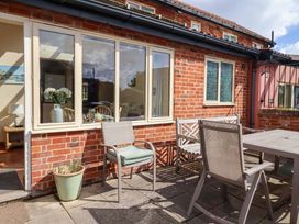 An outdoor seating area with chairs and a table at Churn House Ipswich