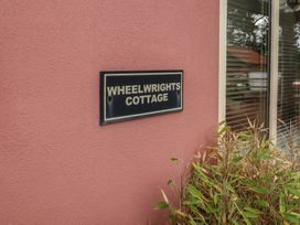 A nameplate for Wheelwright's Cottage at the exterior of a building in Ipswich