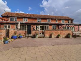An outdoor view of a house with doors and windows at Wheelwright's Cottage in Ipswich