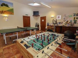 A recreation room with foosball and table tennis tables at Wheelwright's Cottage Ipswich