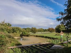 A park with trees and water at Wheelwright's Cottage in Ipswich