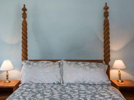 A bed with pillows and nightstands at Billy's Barn in Bradworthy
