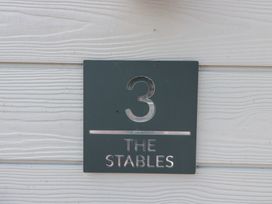 A sign displaying number 3 and The Stables at 3 The Stables Highbridge