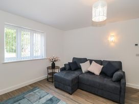 A living room with a sofa and window at 3 The Stables in Highbridge