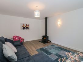A living room with a fireplace and sofa at 3 The Stables in Highbridge