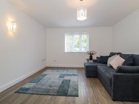 A living room with a sofa and rug at 3 The Stables in Highbridge