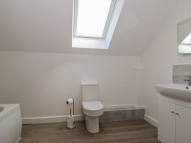 A bathroom with a toilet, sink, and bathtub at 3 The Stables Highbridge