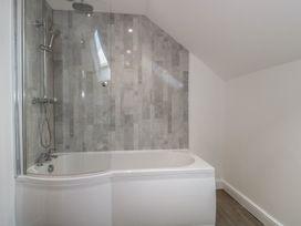A bathroom with a bathtub and shower at 3 The Stables in Highbridge