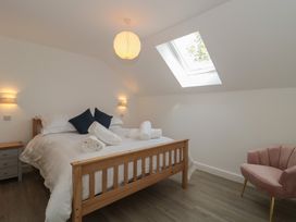 A bedroom with a bed and nightstand at 3 The Stables Highbridge