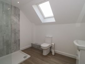 A bathroom with a shower, toilet, and sink at 3 The Stables Highbridge