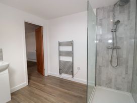 A bathroom with a shower and sink at 3 The Stables Highbridge