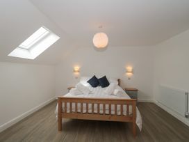A bedroom with a bed and bedside table at 3 The Stables in Highbridge