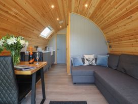 A living room with a kitchenette and a sofa at Barley near Nelson