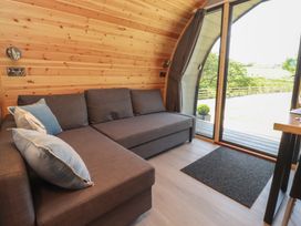 A snug with a couch and large window at Barley near Nelson