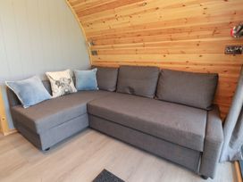 A living room with a gray sofa and cushions at Barley near Nelson