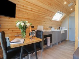 A kitchen with flowers on the table at Barley near Nelson