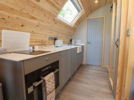A kitchen with cabinets, sink, and oven at Barley near Nelson