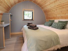 A bedroom with a bed and towels on display at Barley near Nelson