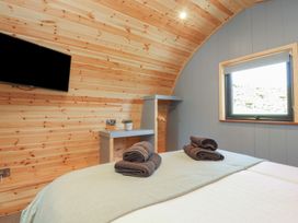 A bedroom with a bed and TV at Barley near Nelson