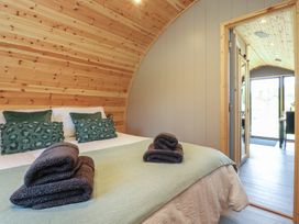 A bedroom with a bed and door to outside at Barley near Nelson