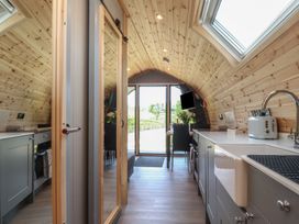 A kitchen with a table and chairs at Barley near Nelson