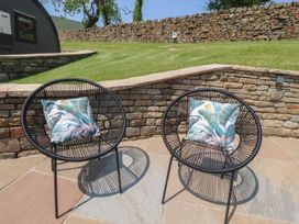 Two black chairs with decorative pillows on a patio at Black Moss Nelson