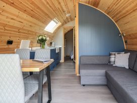 A living room with a table and chairs at Black Moss in Nelson