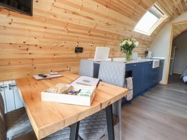 A kitchen with a table and chairs at Black Moss in Nelson