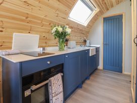 A kitchen with a sink and flowers on the countertop at Black Moss in Nelson