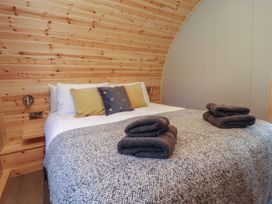 A bedroom with a bed and pillows at Black Moss in Nelson
