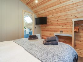 A bedroom with a bed and towels at Black Moss in Nelson