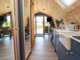 A kitchen with a sink and dining table at Black Moss in Nelson