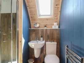 A bathroom with a shower, sink, and toilet at Black Moss in Nelson