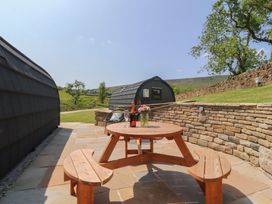 An outdoor seating area with a table and chairs at Black Moss in Nelson