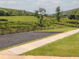 An outdoor area with a pathway, gravel and trees at Black Moss in Nelson