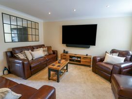 A living room with a TV, sofas, and a coffee table at 20 Cysgod Y Bryn Rhos-On-Sea