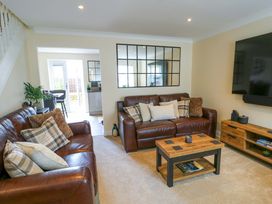 A living room with sofas and a coffee table at 20 Cysgod Y Bryn in Rhos-On-Sea