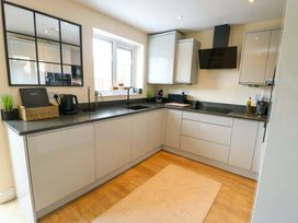 A kitchen with a sink and cabinets at 20 Cysgod Y Bryn Rhos-On-Sea