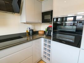 A kitchen with appliances and cabinetry at 20 Cysgod Y Bryn Rhos-On-Sea