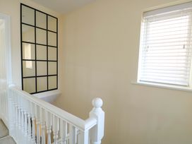 A hallway with a staircase and window at 20 Cysgod Y Bryn Rhos-On-Sea