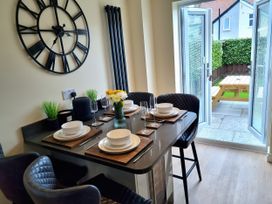 A dining room with a table set for meals at Hafan Rhos in Rhos-On-Sea