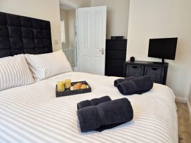 A bedroom with a bed and towels on it at Hafan Rhos in Rhos-On-Sea