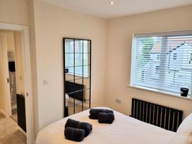A bedroom with a bed and towels at Hafan Rhos in Rhos-On-Sea