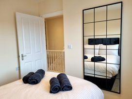 A bedroom with a bed and towels at Hafan Rhos Rhos-On-Sea