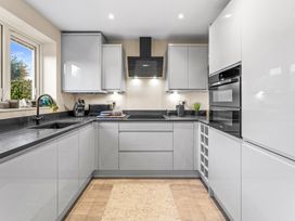A kitchen with cabinets and a sink at Hafan Rhos in Rhos-On-Sea