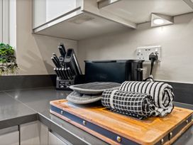 A kitchen counter with a knife block and a toaster at Hafan Rhos in Rhos-On-Sea