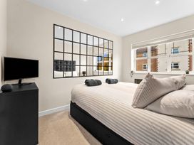 A bedroom with a bed and TV at Hafan Rhos in Rhos-On-Sea