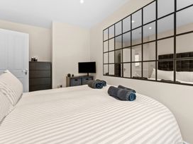 A bedroom with a bed and towels on top at Hafan Rhos in Rhos-On-Sea